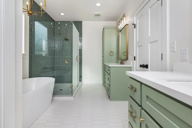 a bathroom with a double vanity sink toilet and shower