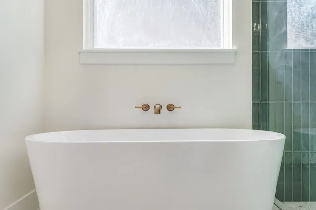 a white bath tub sitting in a bathroom