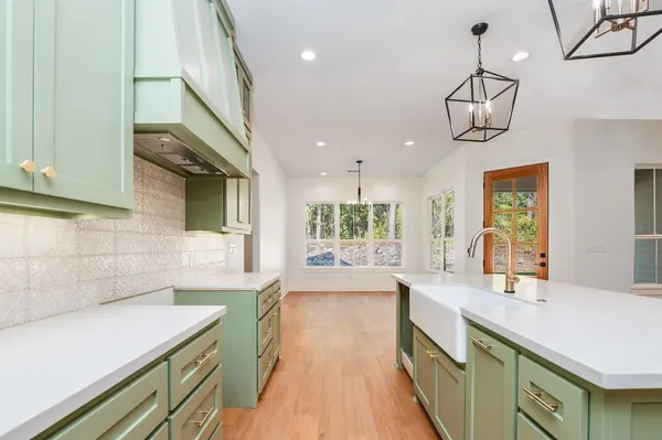 a kitchen with a sink and chandelier