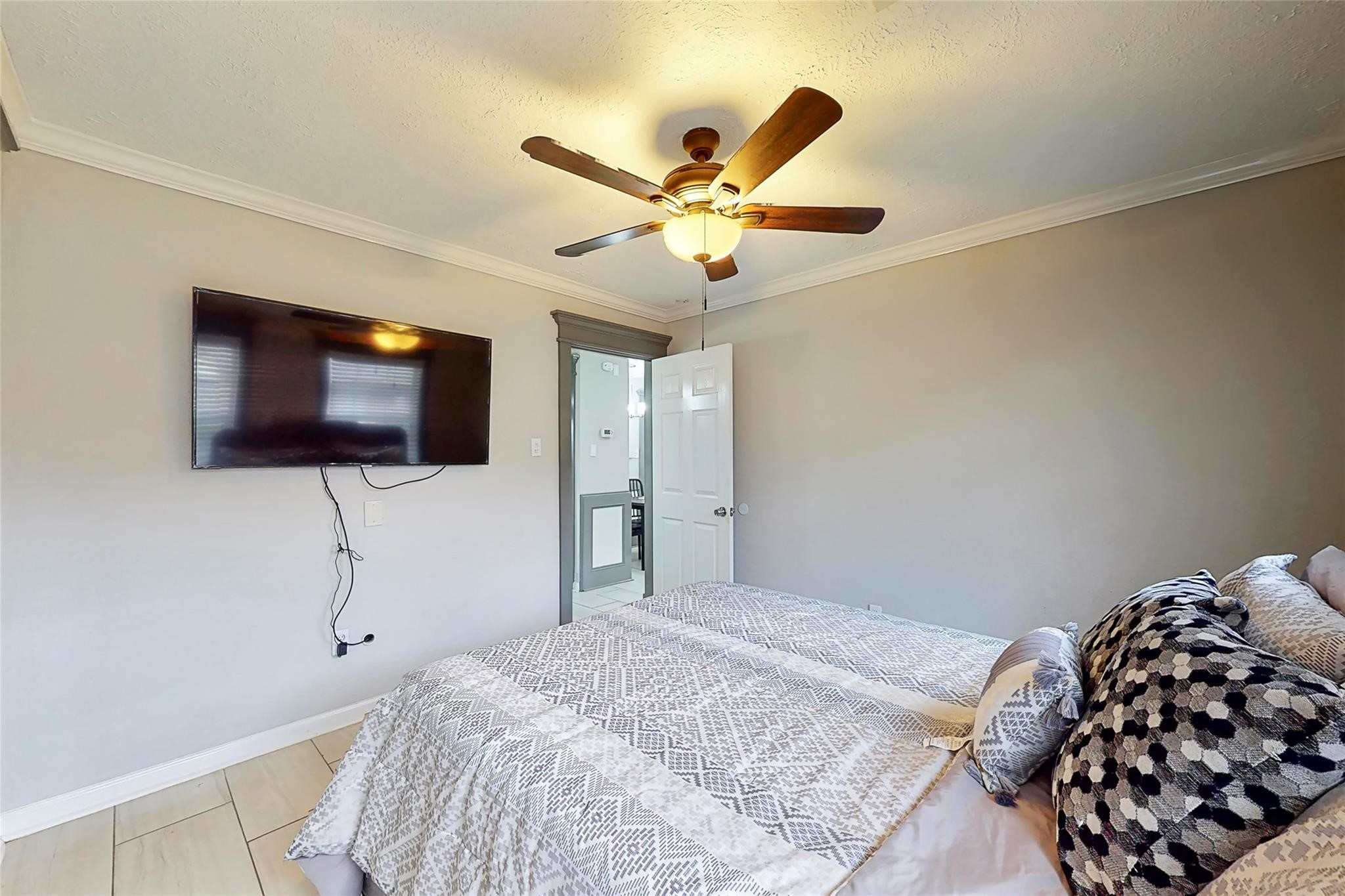 7825 Cook Road Houston, TX 77072 - Photo 11 of 13 a bedroom with a bed and a flat screen tv