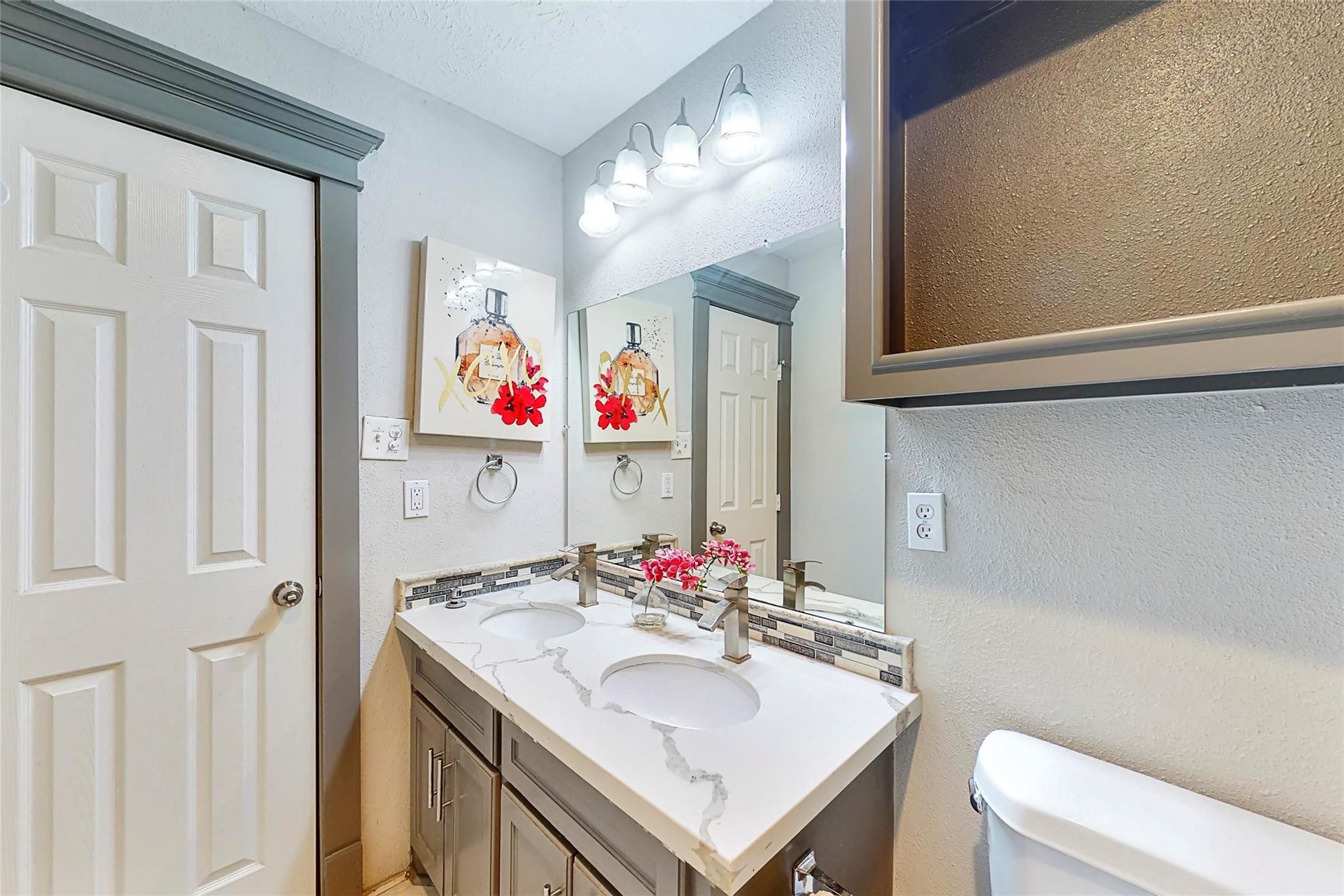 7825 Cook Road Houston, TX 77072 - Photo 12 of 13 a bathroom with a sink vanity mirror and toilet