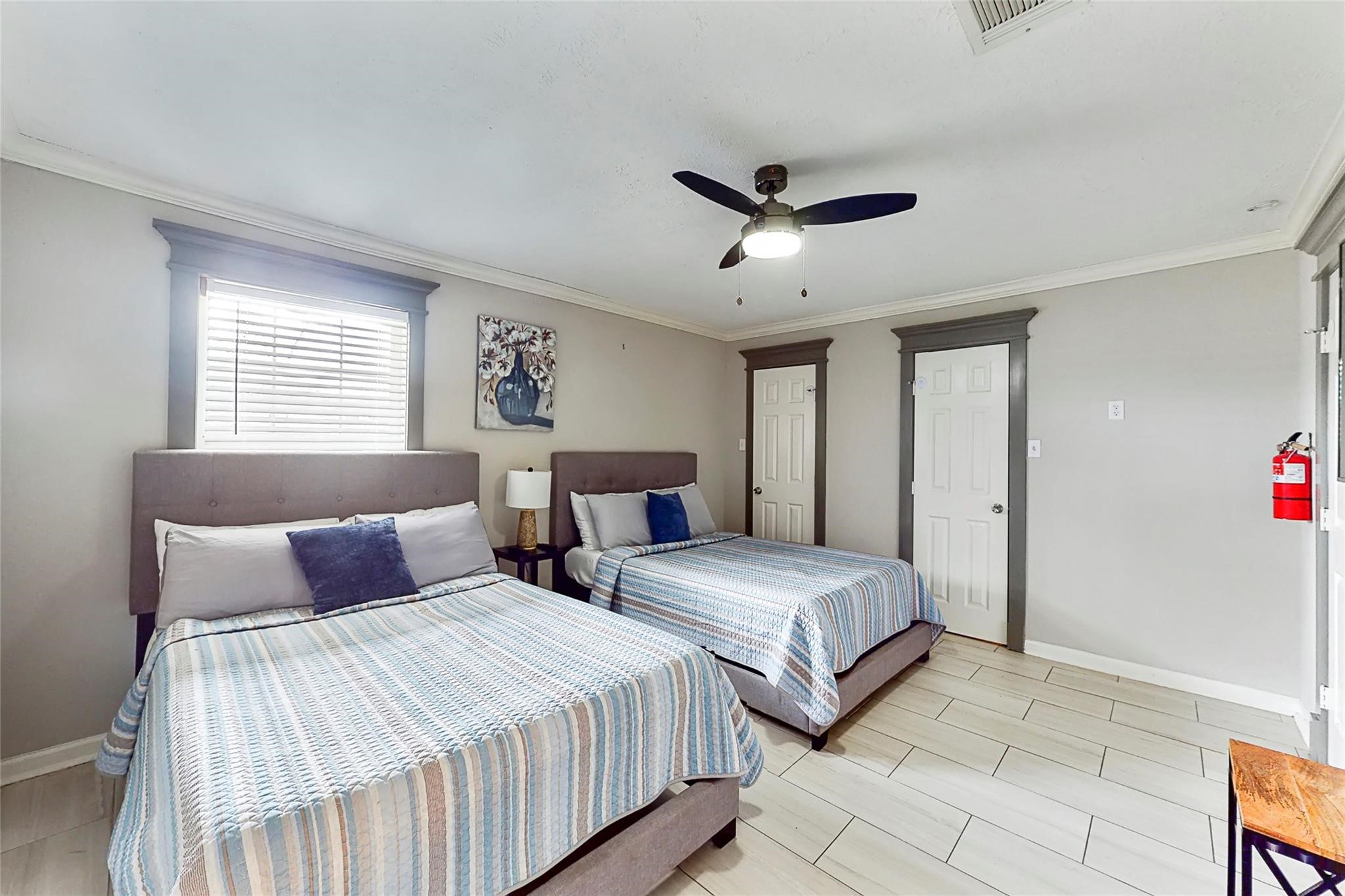 7825 Cook Road Houston, TX 77072 - Photo 3 of 13 a bedroom with two beds and a chandelier