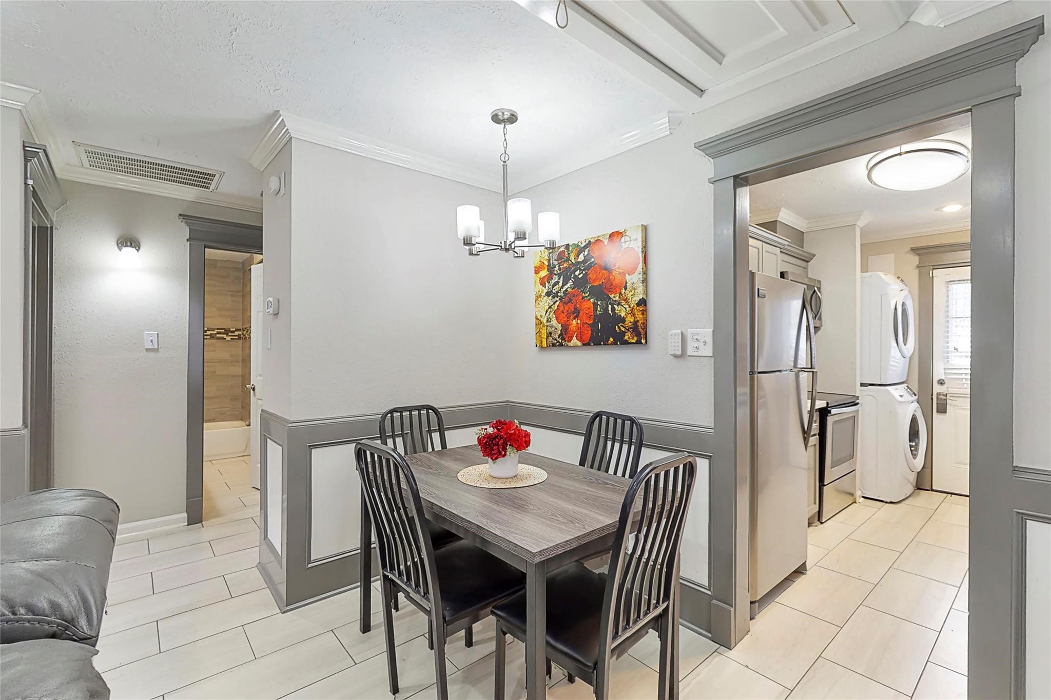 7825 Cook Road Houston, TX 77072 - Photo 7 of 13 a view of a dining room with furniture a chandelier and wooden floor