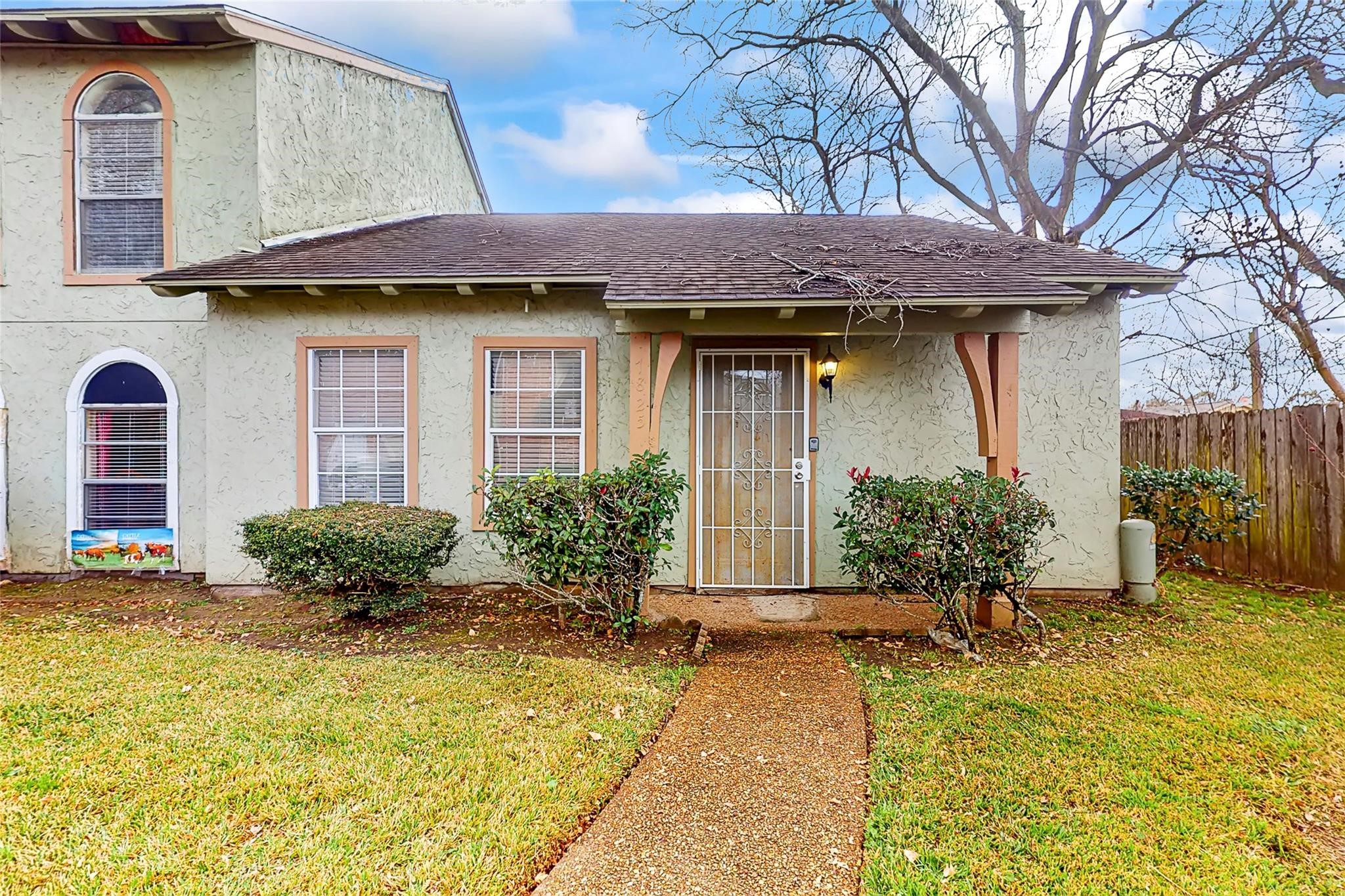 7825 Cook Road Houston, TX 77072 - Photo 9 of 13 a front view of a house with garden
