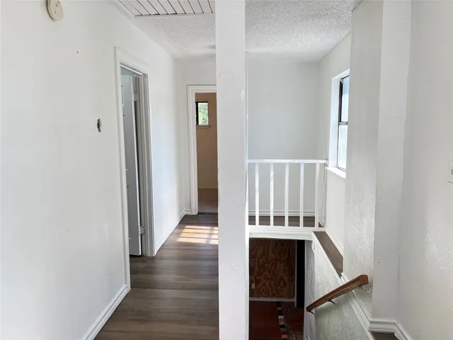 a view of an entryway with wooden floor