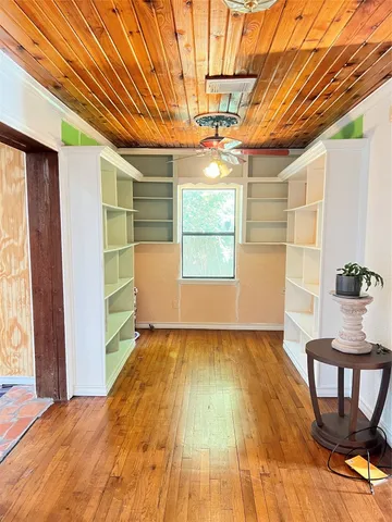 a view of a room with wooden floor and chair