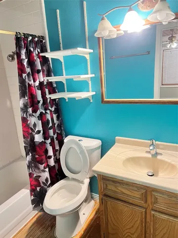 a bathroom with a sink mirror and toilet