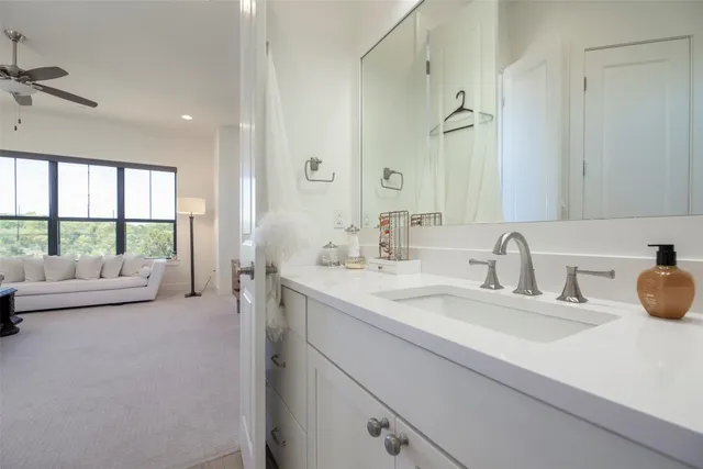 a bathroom with a sink shower and a mirror