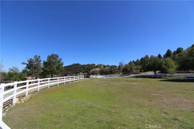 a table with chairs and a table with wooden fence