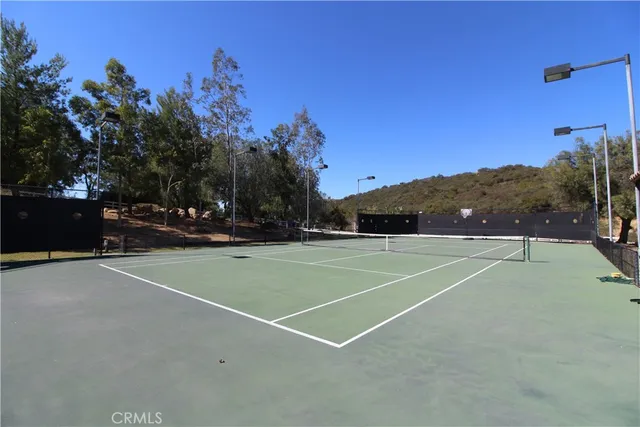 a view of house with a large window and potted plants