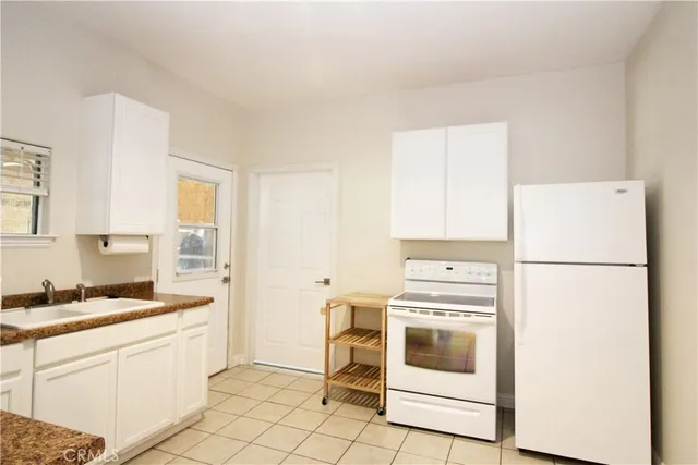 a kitchen with a stove a sink and a refrigerator