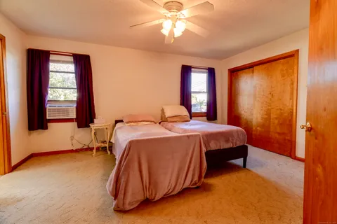 a bedroom with a bed and window