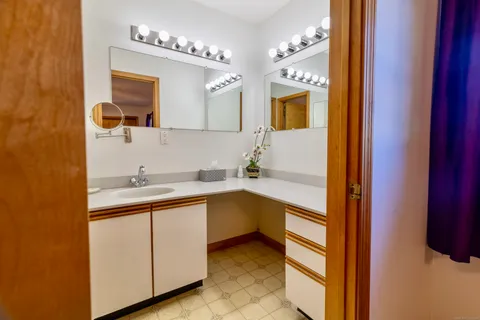 a bathroom with a sink and a mirror