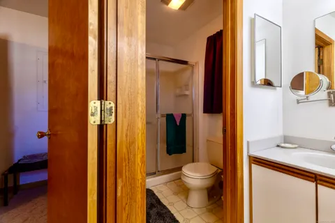 a bathroom with a toilet and a shower