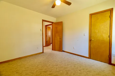 a view of a big room with closet and chandelier fan