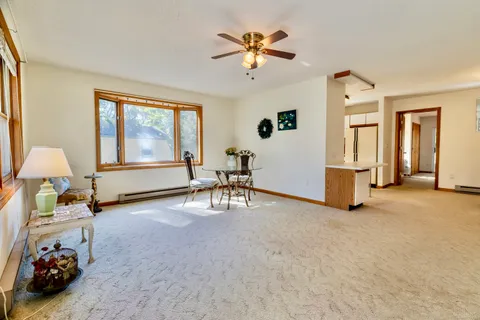 a view of an empty room with window and a fireplace