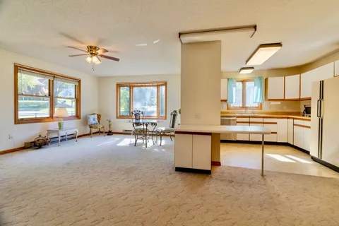 a view of a livingroom with furniture and a window