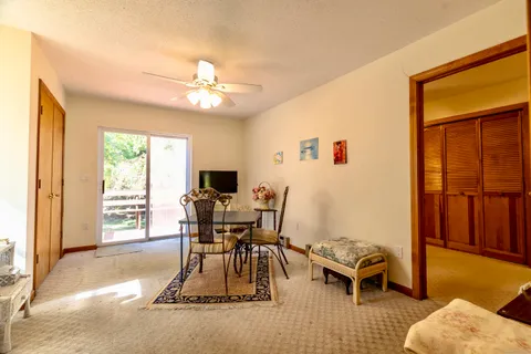 a dining room with furniture a chandelier and wooden floor