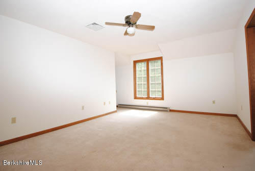 96 Scacebrook Road Richmond, MA 01201 - Photo 21 of 25 an empty room with a window and a ceiling fan