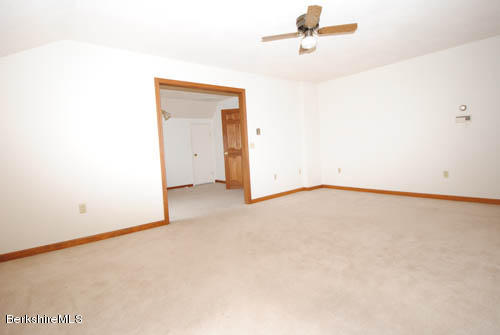 96 Scacebrook Road Richmond, MA 01201 - Photo 25 of 25 an empty room with a ceiling fan and wooden floor