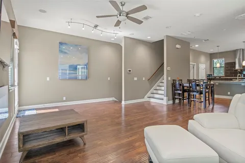 a living room with furniture and wooden floor