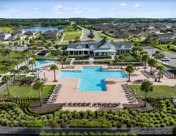an aerial view of residential houses with outdoor space and swimming pool