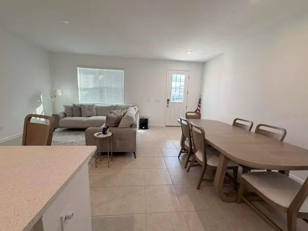 a living room with furniture a table and a window