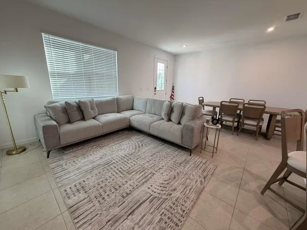 a living room with furniture and a window