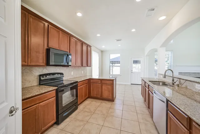 a sink with granite countertop a sink and cabinets