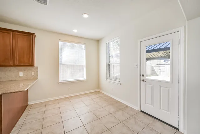 a large kitchen with stainless steel appliances a large counter top and a stove