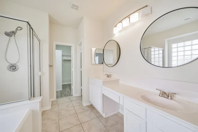 a white bath tub sitting next to a shower