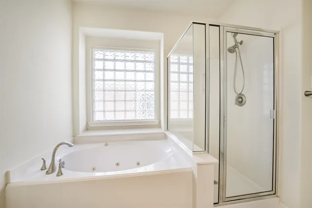 a bathroom with a bathtub and a shower