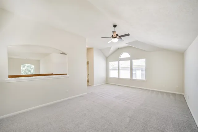 a view of room with a ceiling fan and window