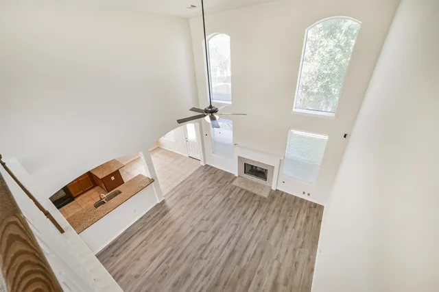 a view of a livingroom with wooden floor and stairs