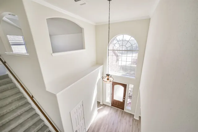 an empty room with a window and a fan