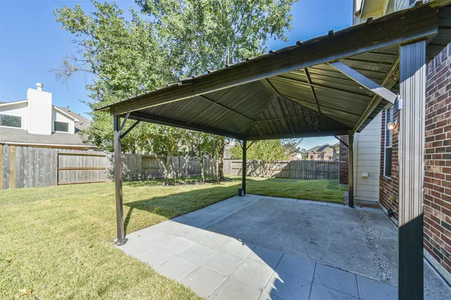 a yellow house with trees in front of it