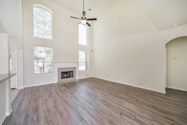 a view of a livingroom with wooden floor and stairs