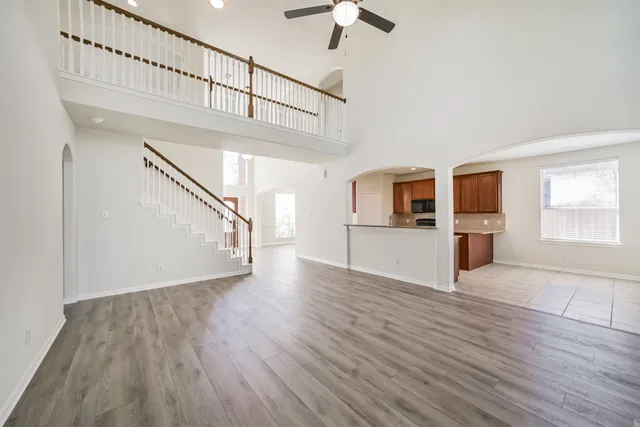 a large kitchen with stainless steel appliances granite countertop a large counter top a stove and a sink