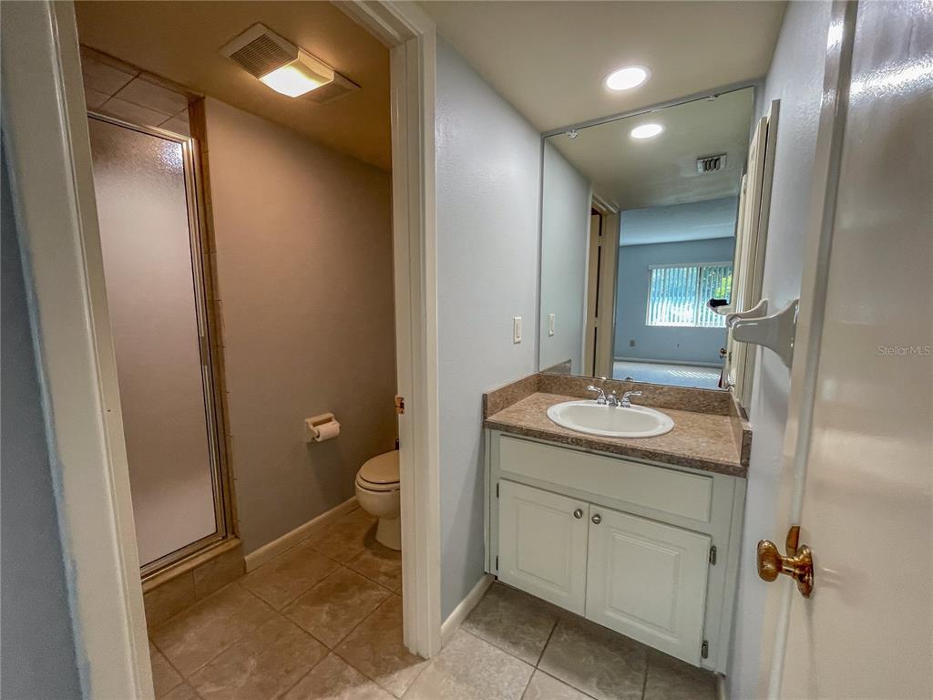 63 Douglas Street, Unit 11 Homosassa, FL 34446 - Photo 16 of 27 a bathroom with a granite countertop sink toilet and shower