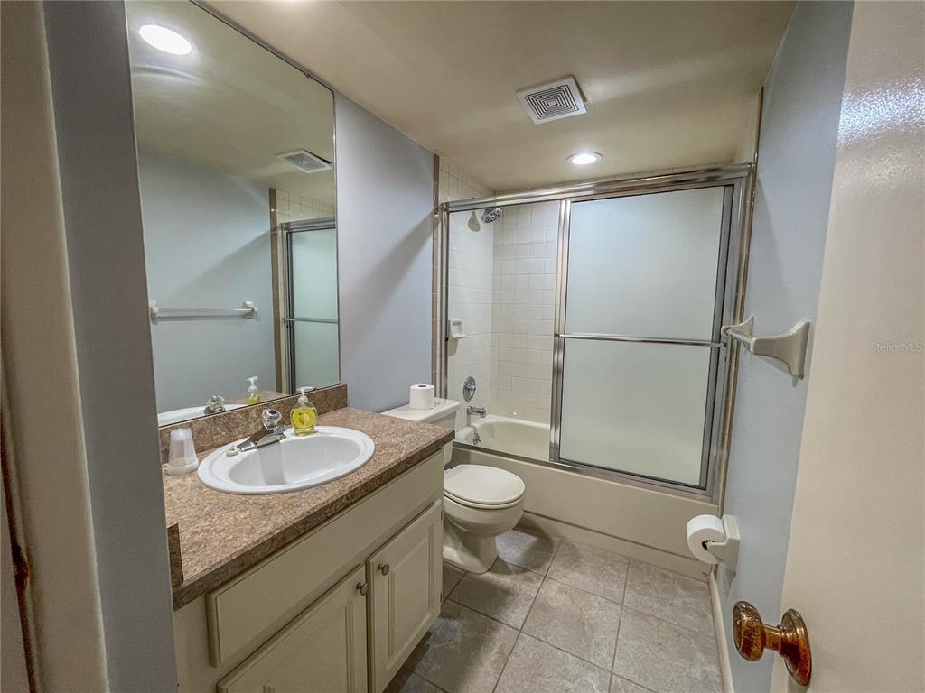 63 Douglas Street, Unit 11 Homosassa, FL 34446 - Photo 23 of 27 a bathroom with a granite countertop sink toilet and shower