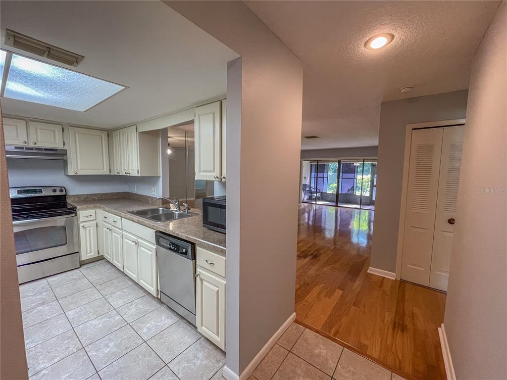 63 Douglas Street, Unit 11 Homosassa, FL 34446 - Photo 7 of 27 a kitchen with granite countertop a refrigerator and a stove top oven