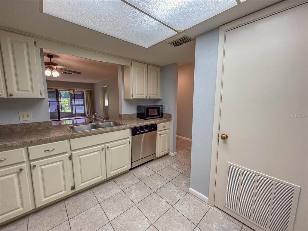 63 Douglas Street, Unit 11 Homosassa, FL 34446 - Photo 9 of 27 a kitchen with granite countertop white cabinets and white appliances