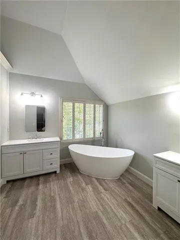 a spacious bathroom with a large tub sink and toilet