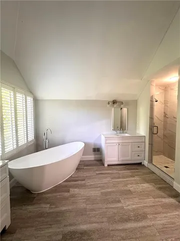 a room with a bed and a dresser