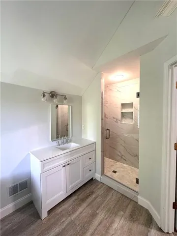 a bathroom with a double vanity sink and mirror