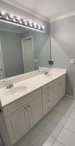 a bathroom with double sink and a mirror