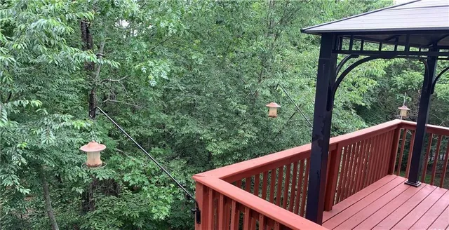 a balcony with wooden floor and outdoor space