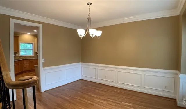 a view of a room with wooden floor and cabinet