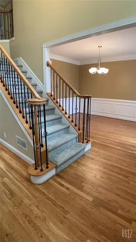 a view of entryway and hall with wooden floor