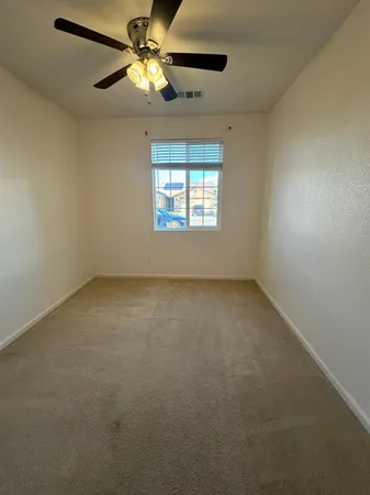a view of room with a ceiling fan and window